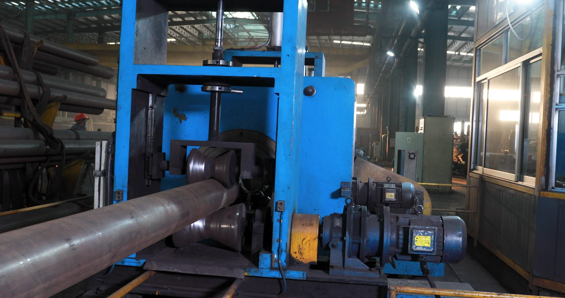 Close-up of steel pipe straightening rollers