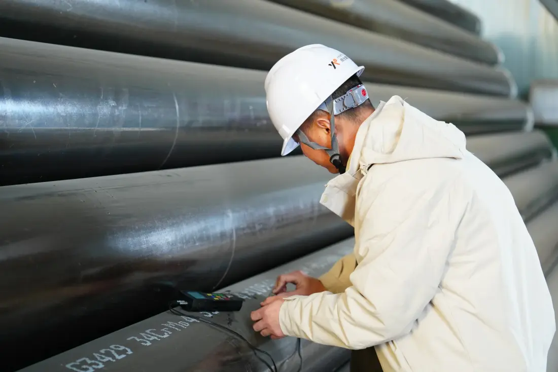 Inspector checking steel pipe markings and material traceability information