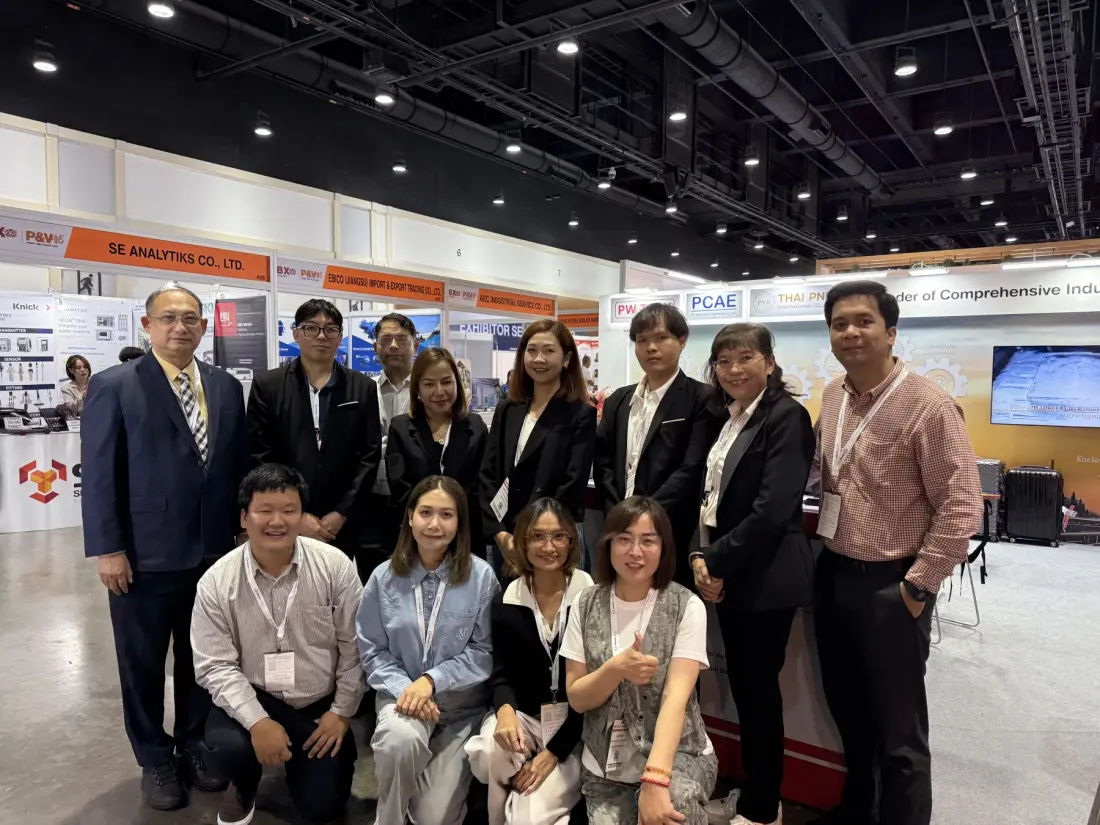 Sales team and customers at an industrial trade show booth